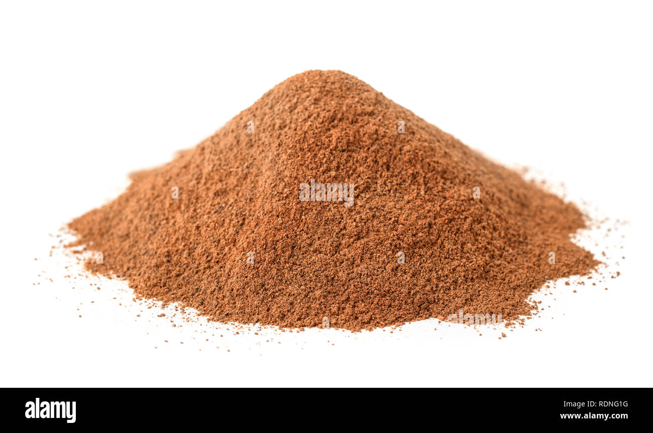 Pile of ground cinnamon isolated on white Stock Photo