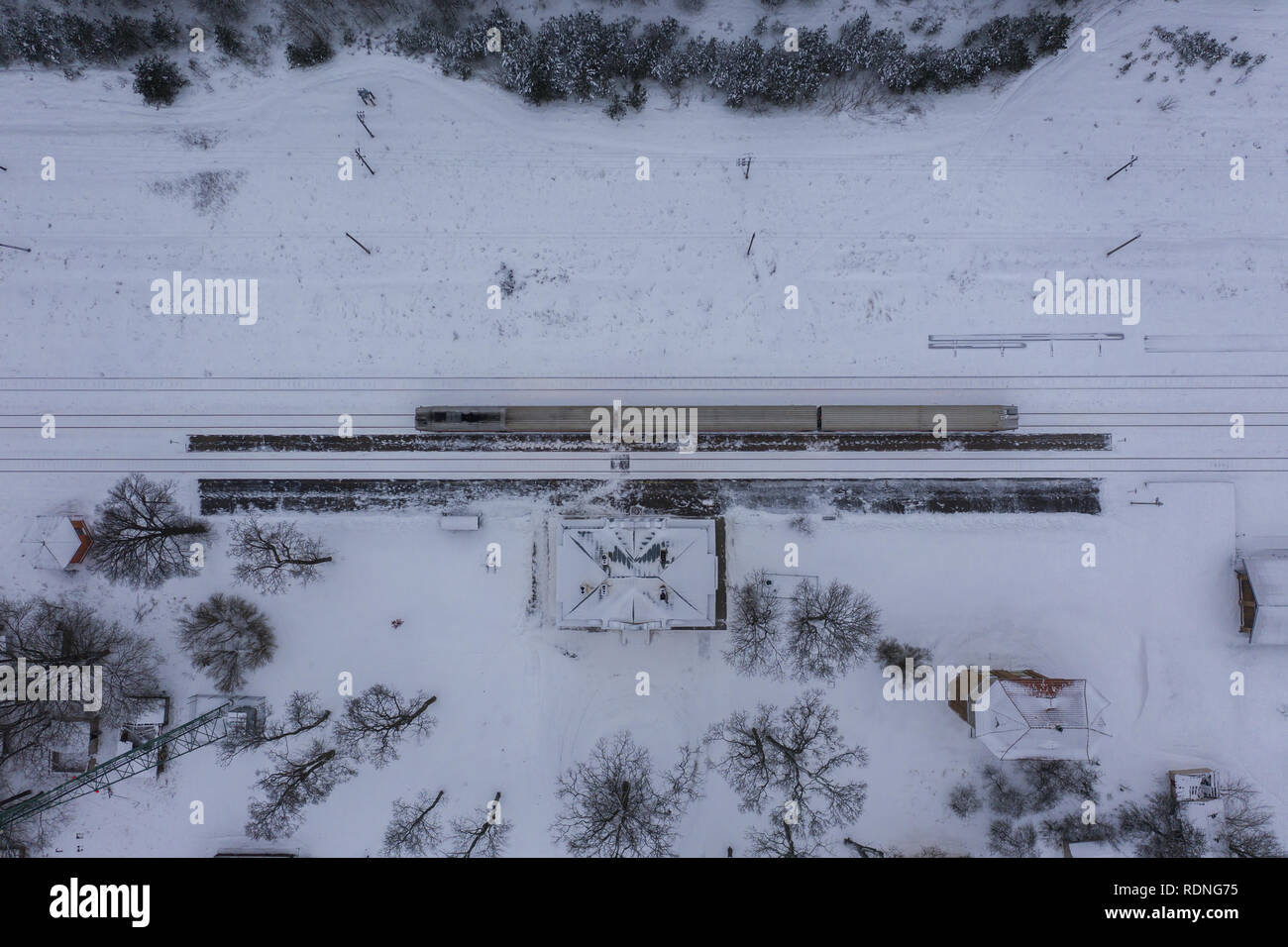 Drone photography of winter forest, locomotive in station and railway ...