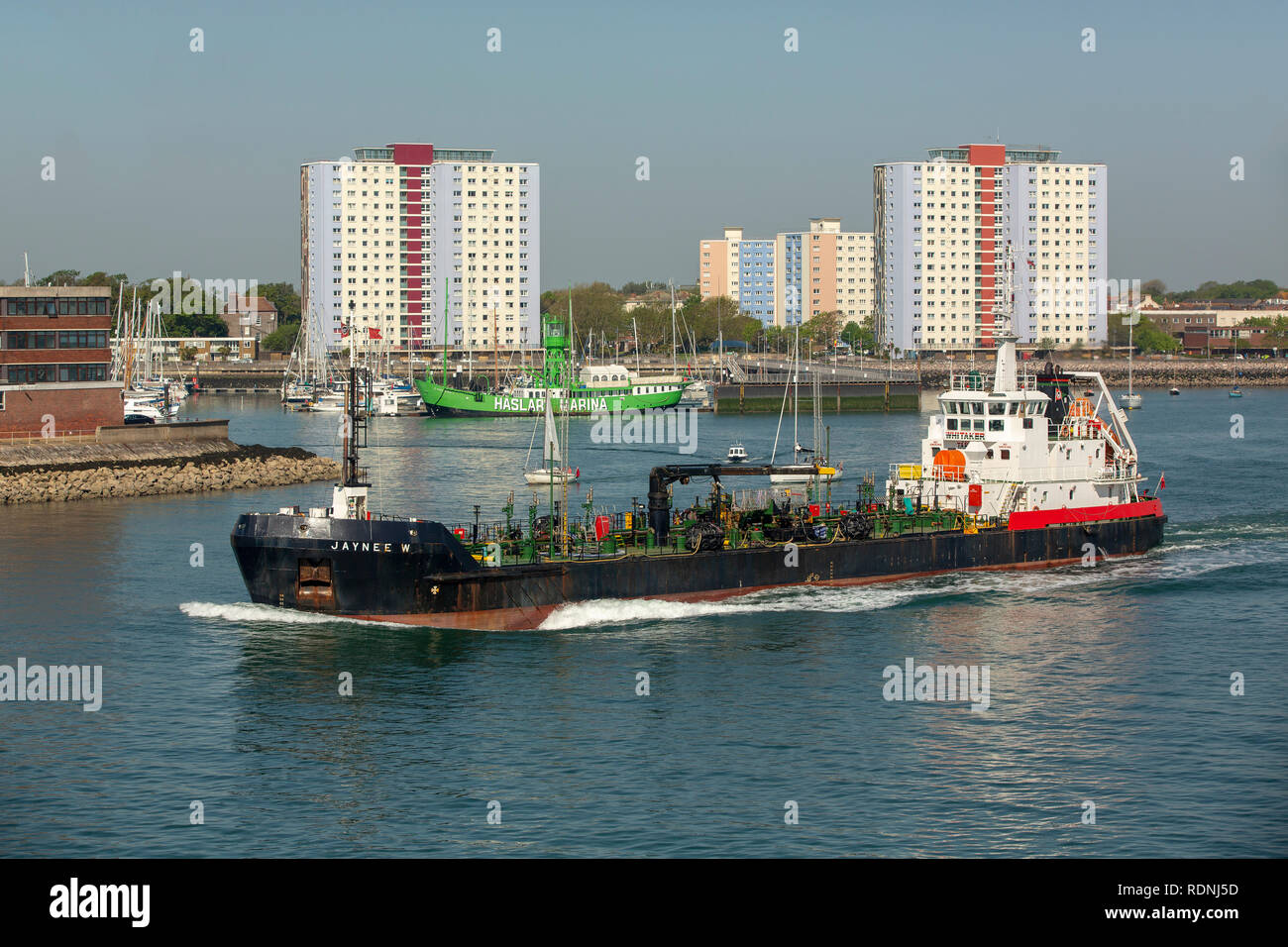 The Jaynee W, a small oil tanker leaving Portsmouth harbour on a clear bright day. It is a utility tanker used for transporting fuel oil. Stock Photo