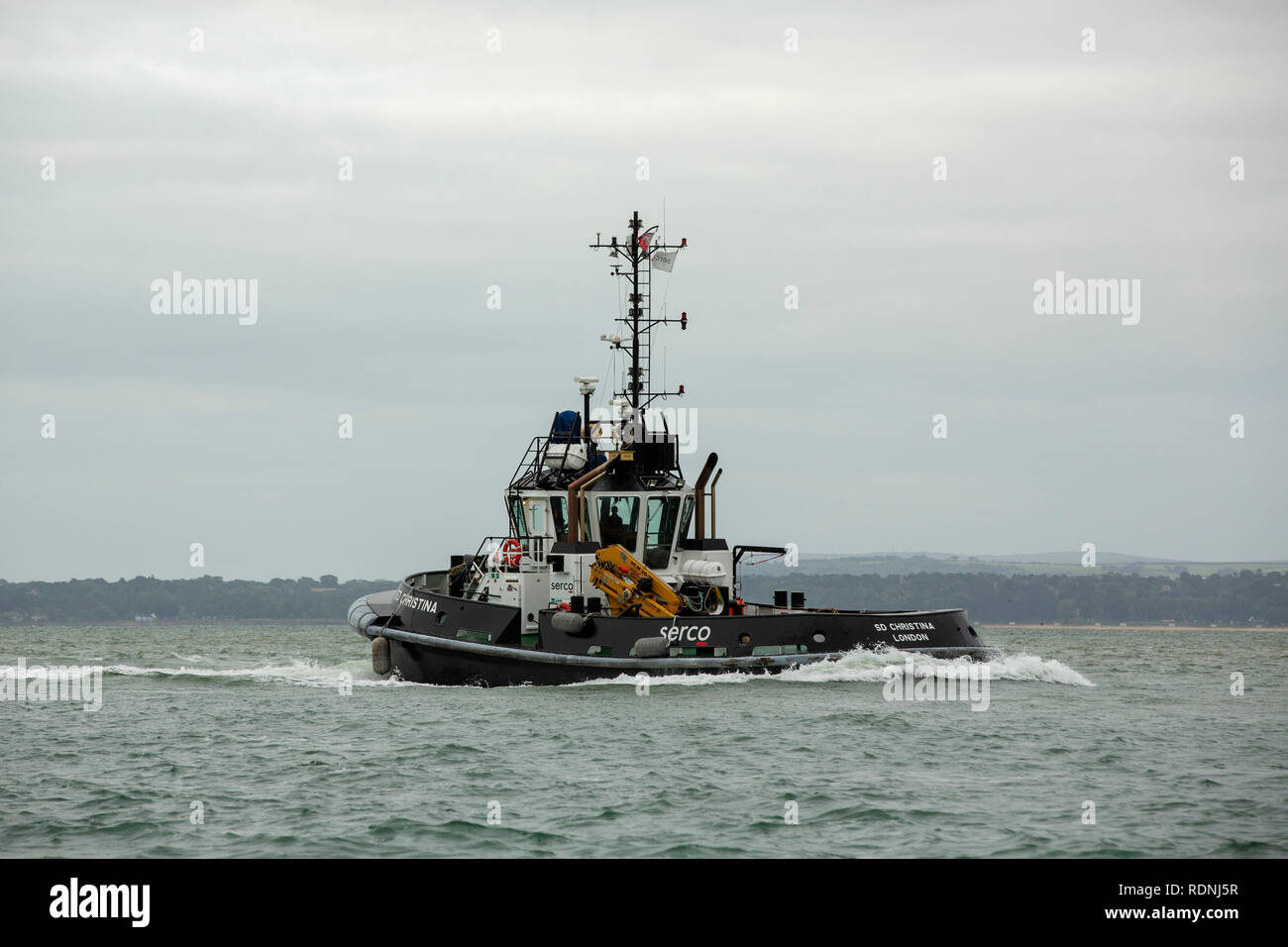 Serco tug at speed in reverse. Returning to port in Portsmouth Hampshire. Stock Photo