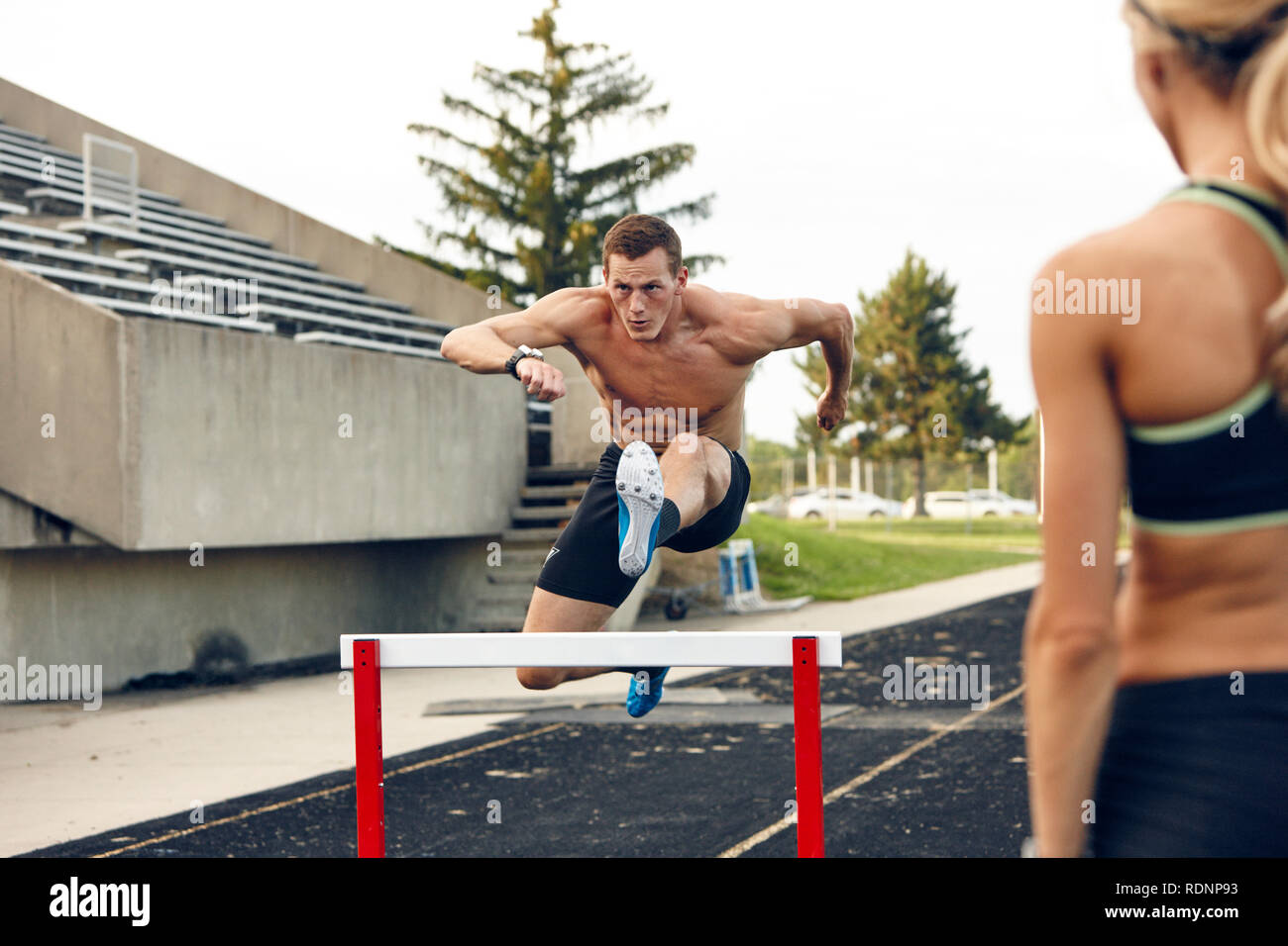 Steeplechaser jumping over barrier Stock Photo Alamy