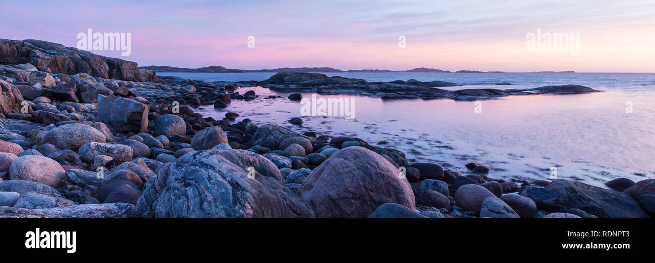Rocky shoreline at sunset Stock Photo