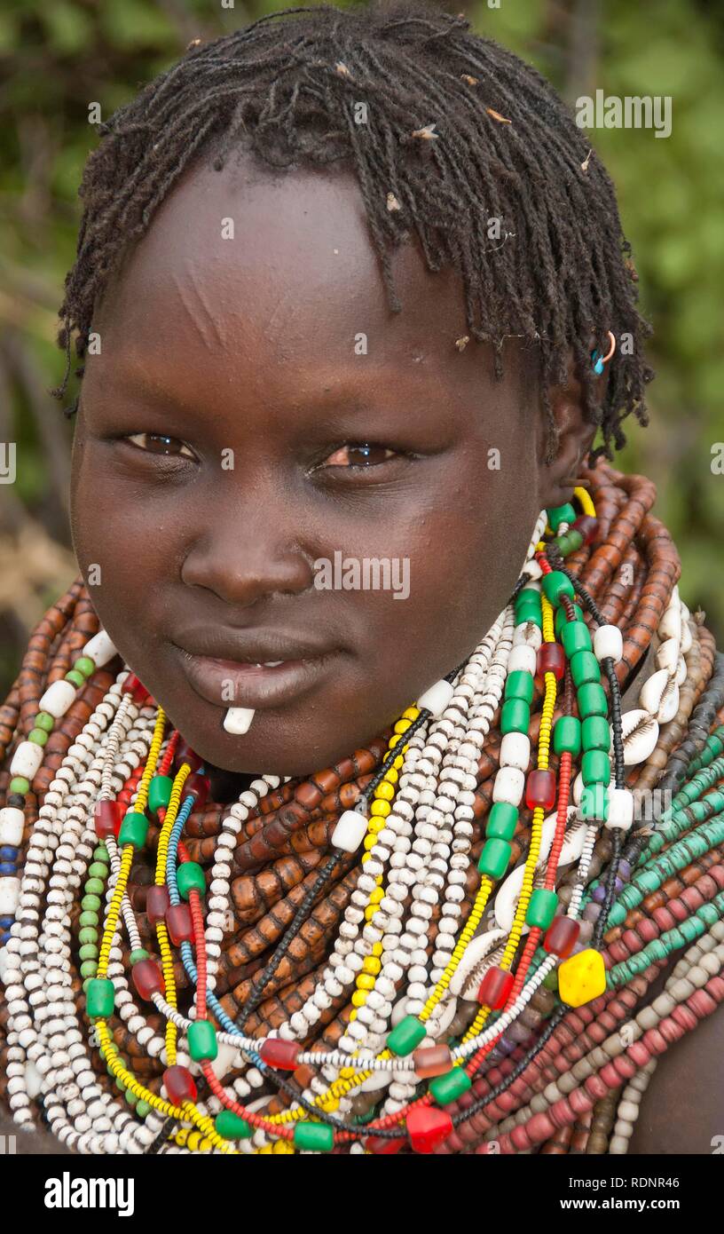 Nyangatom, Bume or Buma woman with bead necklaces in her village, Omo Valley, Ethiopia, Africa Stock Photo