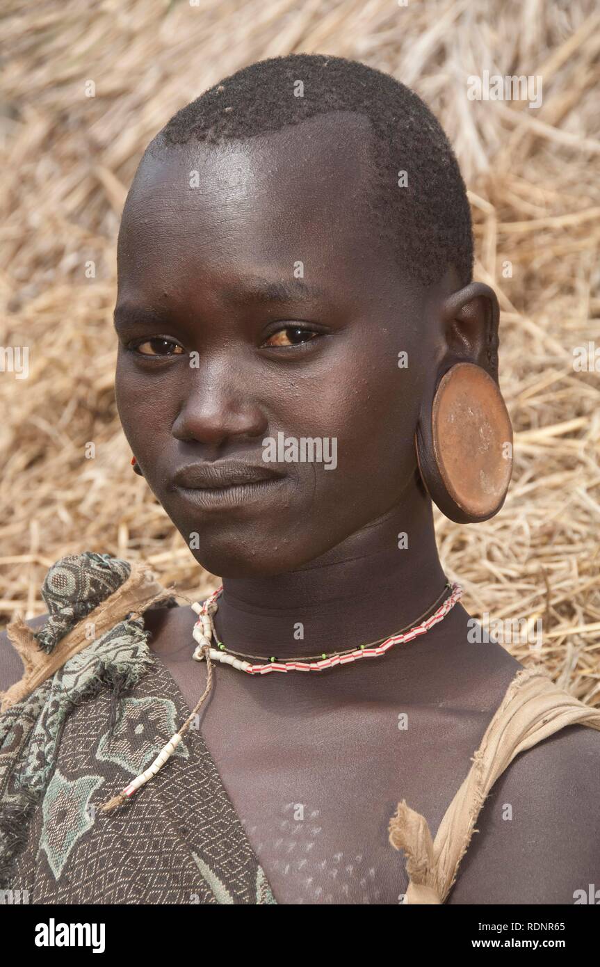 Surma woman wearing earplates, Kibish, Omo valley Valley, Ethiopia, Africa Stock Photo