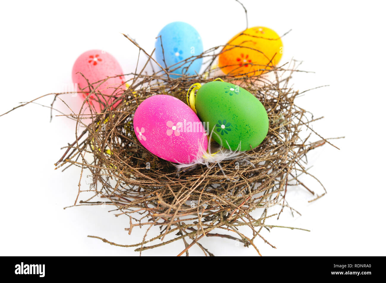 Colorful easter eggs in nest on a white background Stock Photo - Alamy