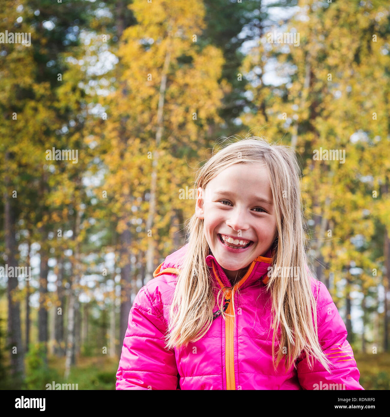 Portrait of girl smiling in front of forest Stock Photo - Alamy