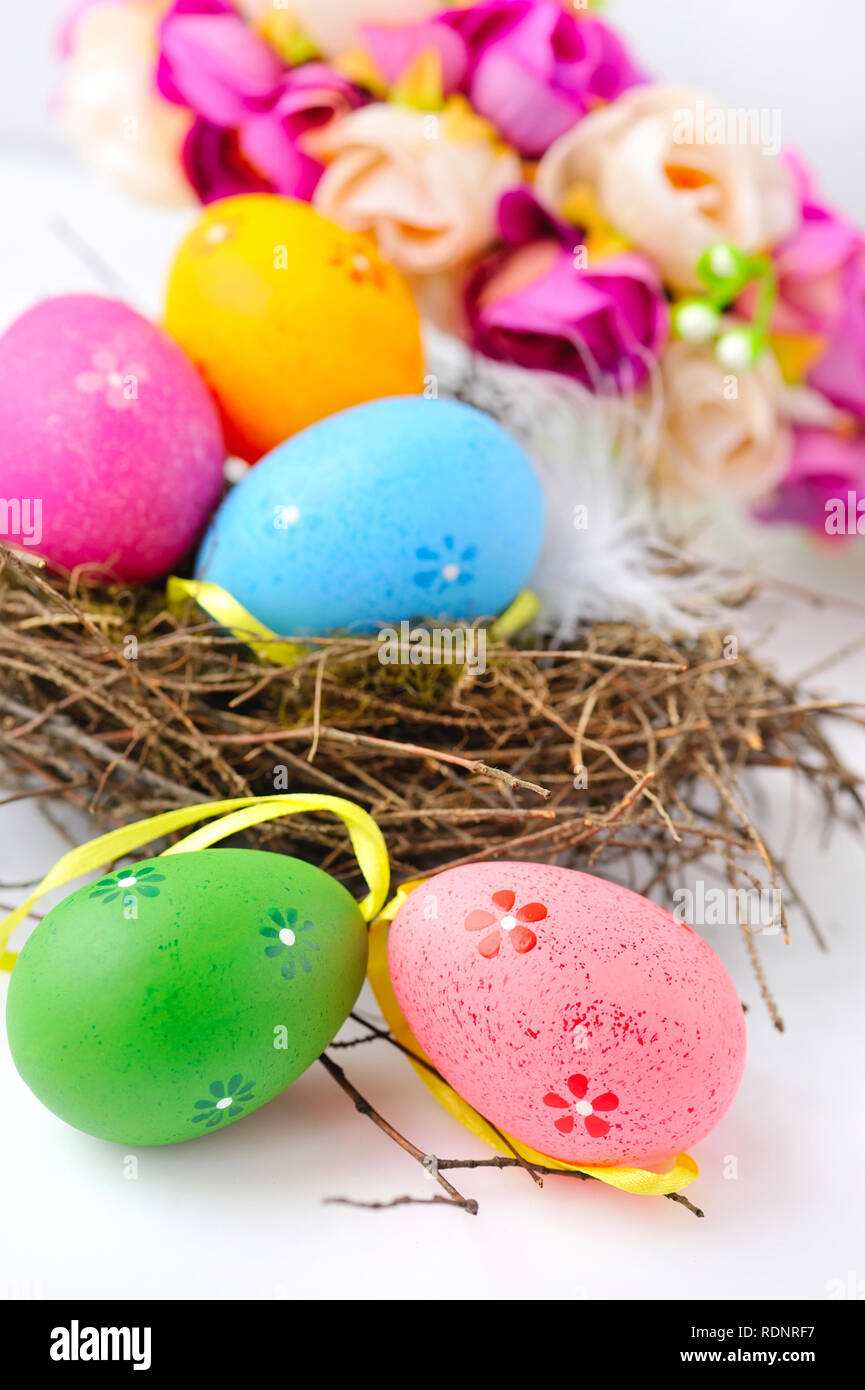 Colorful easter eggs in nest on a white background Stock Photo - Alamy