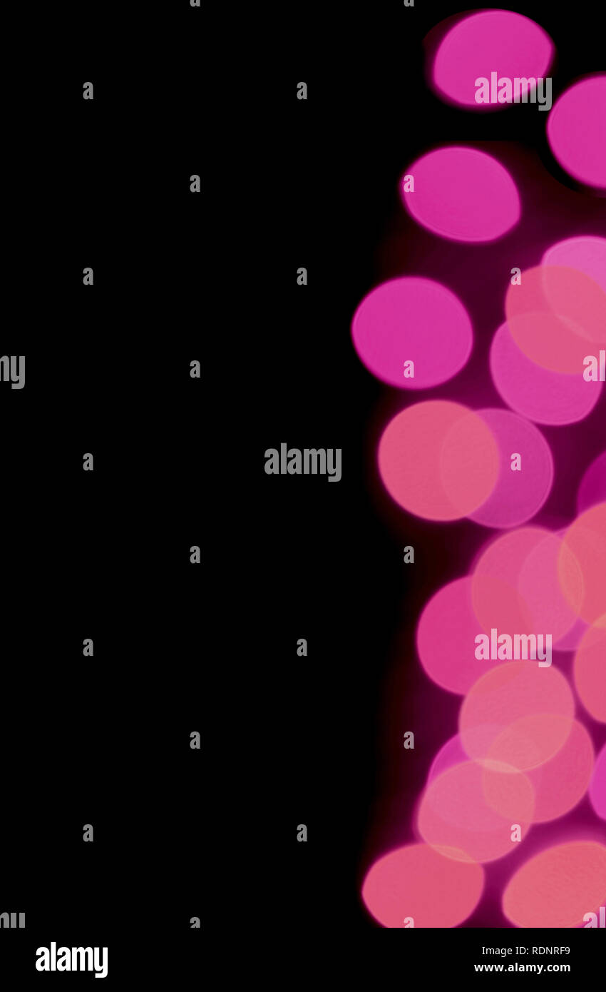 Abstract Blurred Illuminated Lighting in vivid pink color gradations on black background Stock Photo