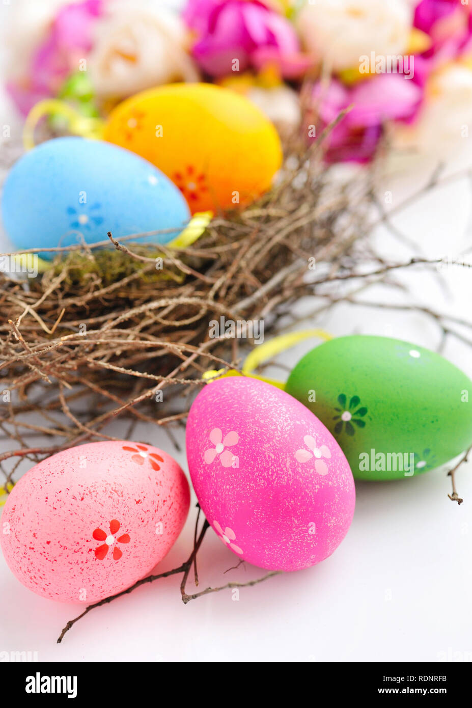 Colorful easter eggs in nest on a white background Stock Photo - Alamy