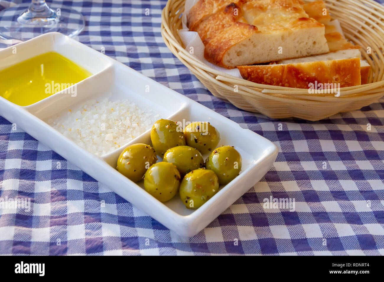 Olives with sea sald, oil and bread Stock Photo