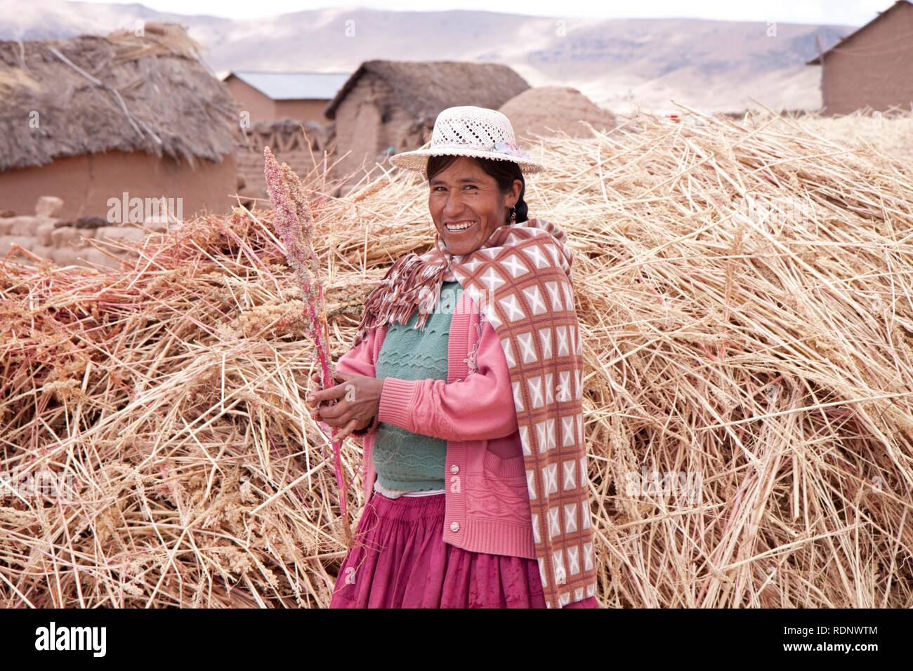 Traditionally dressed woman on a farm in July, Puno, Peru, South America Stock Photo