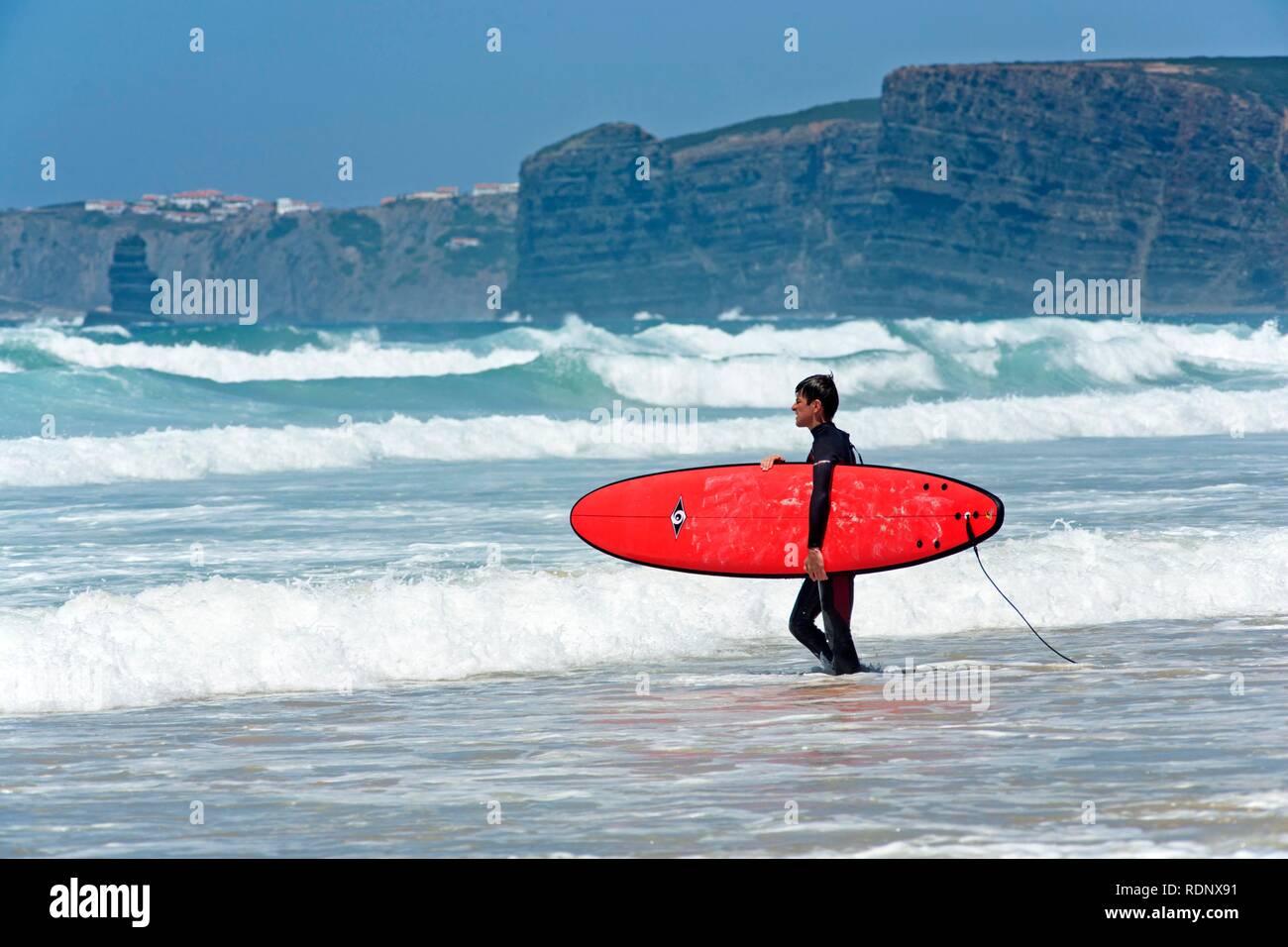 Surfer on the beach of Praia de Vale de Figueira, Costa Dourada, Atlantic Coast, Portugal, Europe Stock Photo