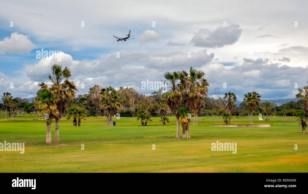 Malaga, Spain - April 07, 2018. A plane landed over the golf course Real Club de Campo de Málaga, Spain Stock Photo