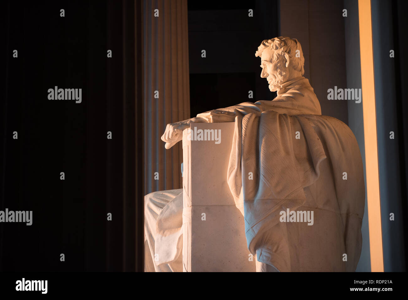 WASHINGTON DC, United States - Early morning at the Lincoln Memorial in Washington DC. Sitting on the western end of the National Mall, it commemorates the 16th president of the United States, Abraham Lincoln. This photo was taken around the spring solstice. With the sun rising directly in the east, the light briefly shines directly onto the massive statue of Lincoln that sits deep inside the building. Stock Photo