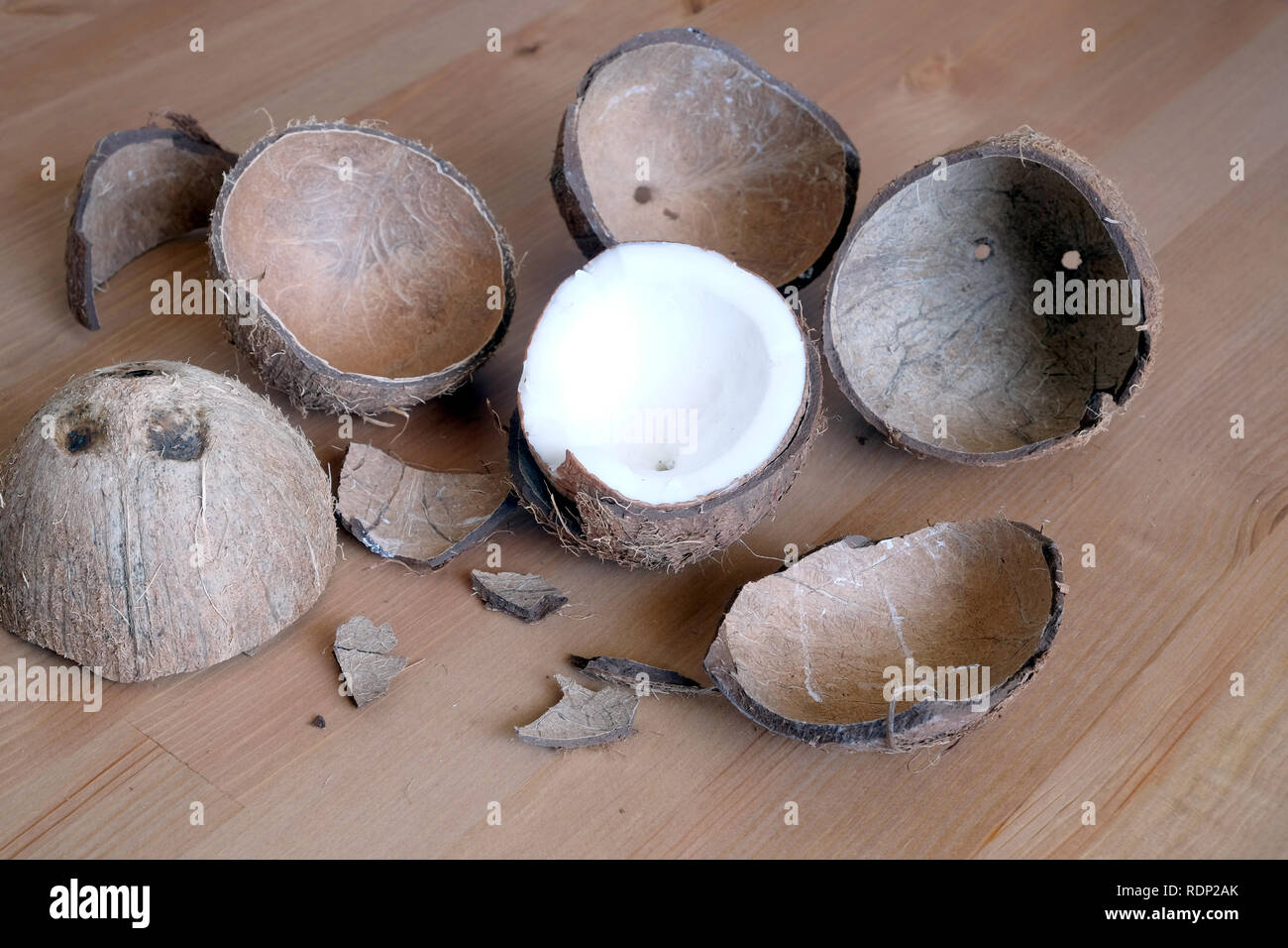 Still life with broken coconut shell ripe white flesh inside and debris