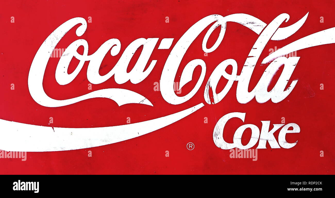 Ameland, Dutch - 22 January 2019.: Coca-Cola logo printed on paper and placed on red background. Coca-Cola is a carbonated soft drink sold in store Stock Photo