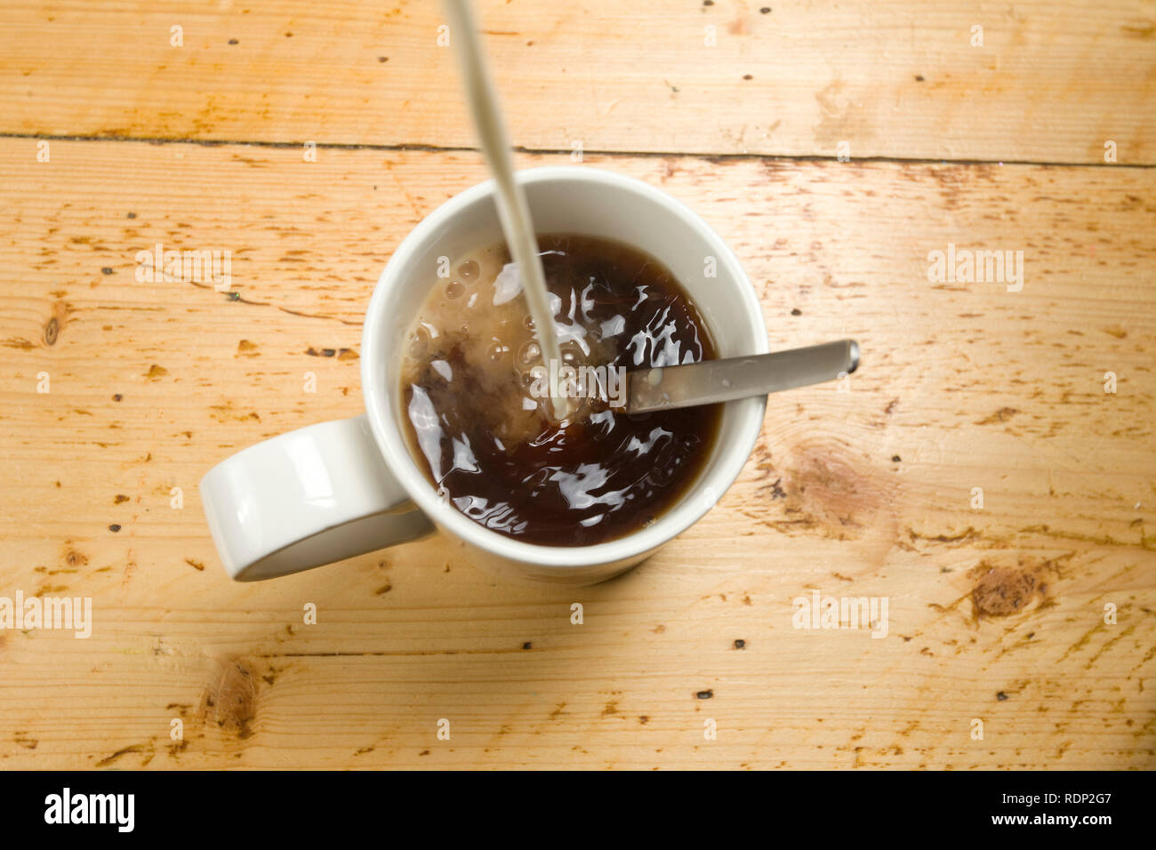 pouring milk in tea Stock Photo