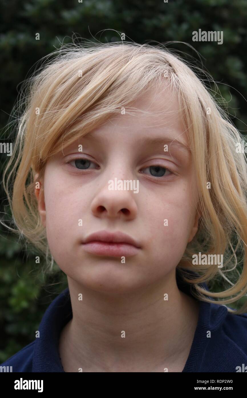 Portrait of a pale unhappy tired listless young blond girl Stock Photo