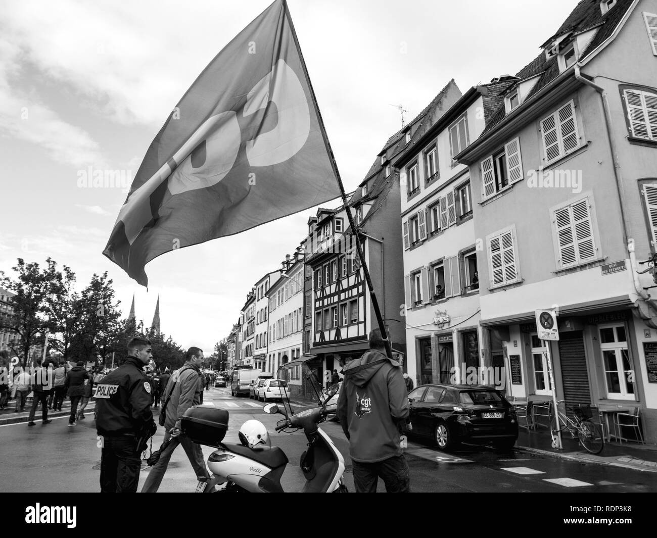STRASBOURG, FRANCE - SEP 12, 2018: Man with CGT flag on street during a French Nationwide day of protest against labor reform proposed by Emmanuel Macron Government - black and white  Stock Photo