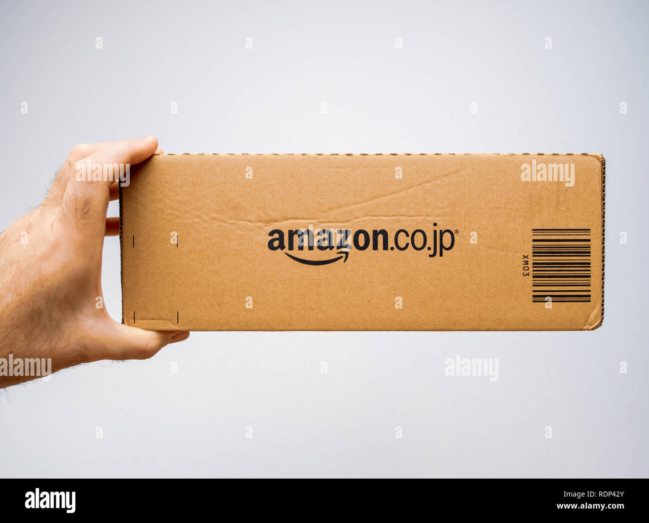 PARIS, FRANCE - FEB 5, 2018: Man holding the side view of Amazon Japan  prime cardboard delivery box parcel against white background - on-line  e-commerce shopping Stock Photo - Alamy