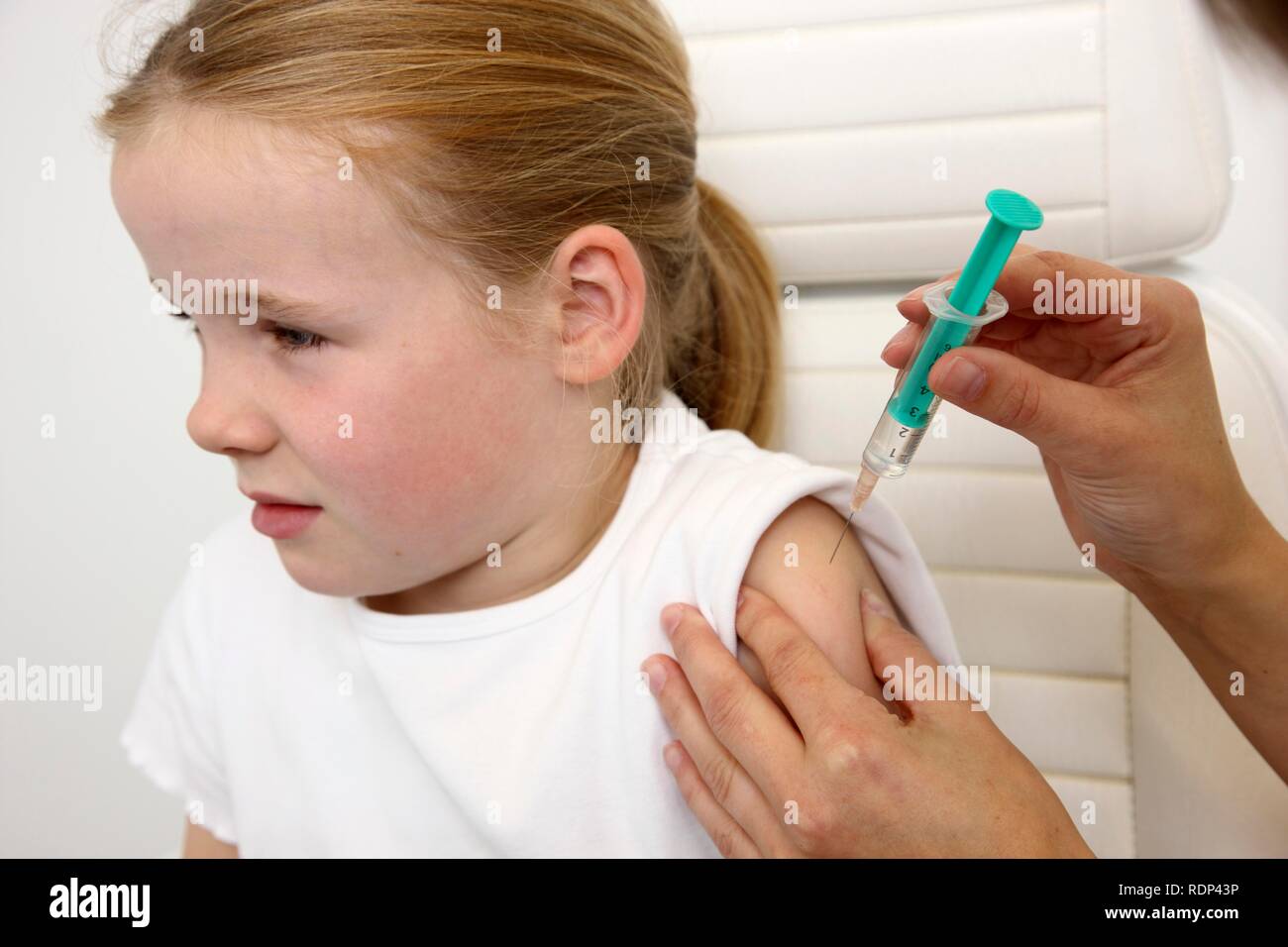 Medical practice, girl, 10 years, injection with a syringe, vaccination ...