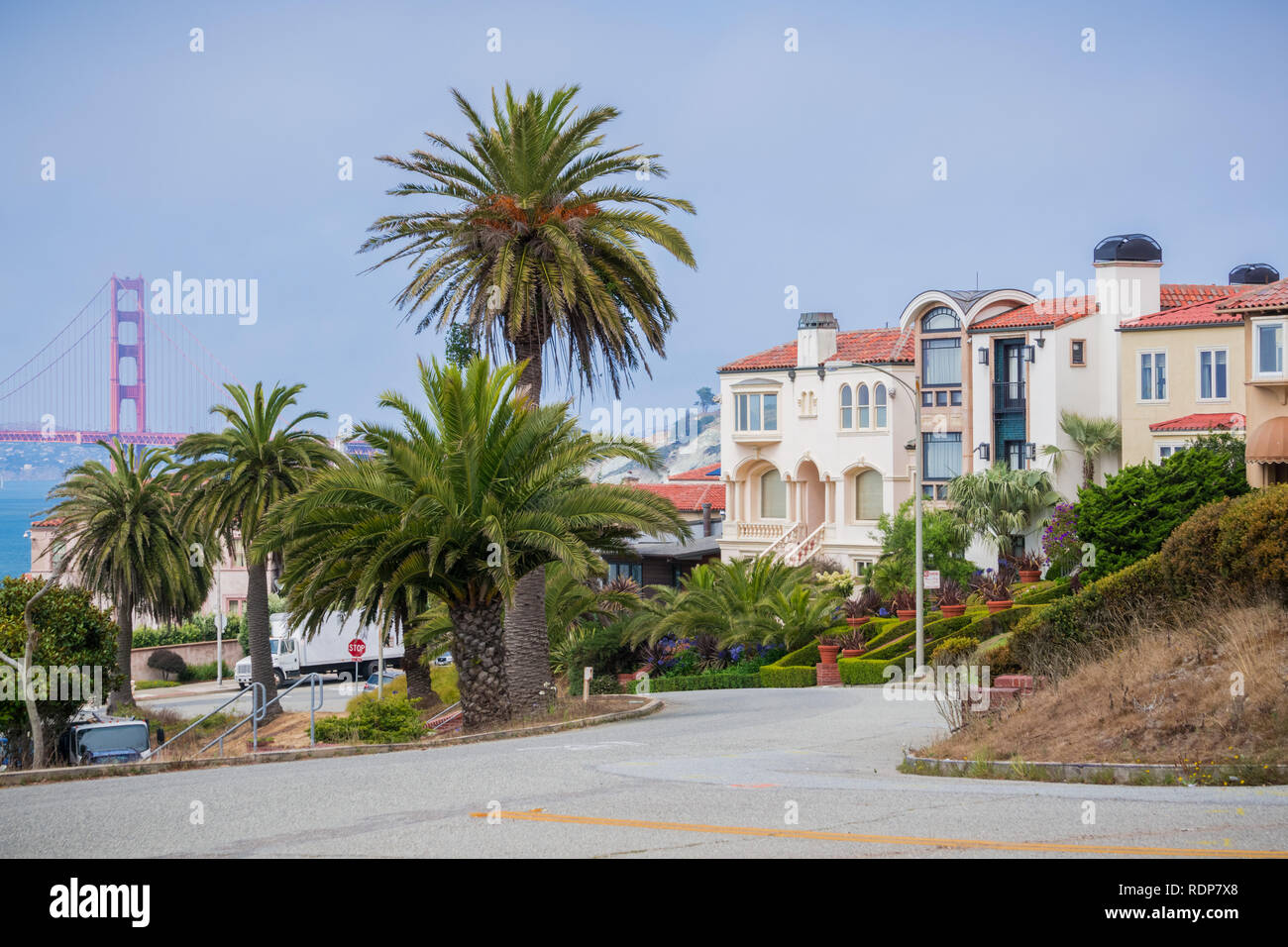 Residential street in the Sea Cliff neighborhood, Golden Gate bridge in the background, San Francisco, California Stock Photo