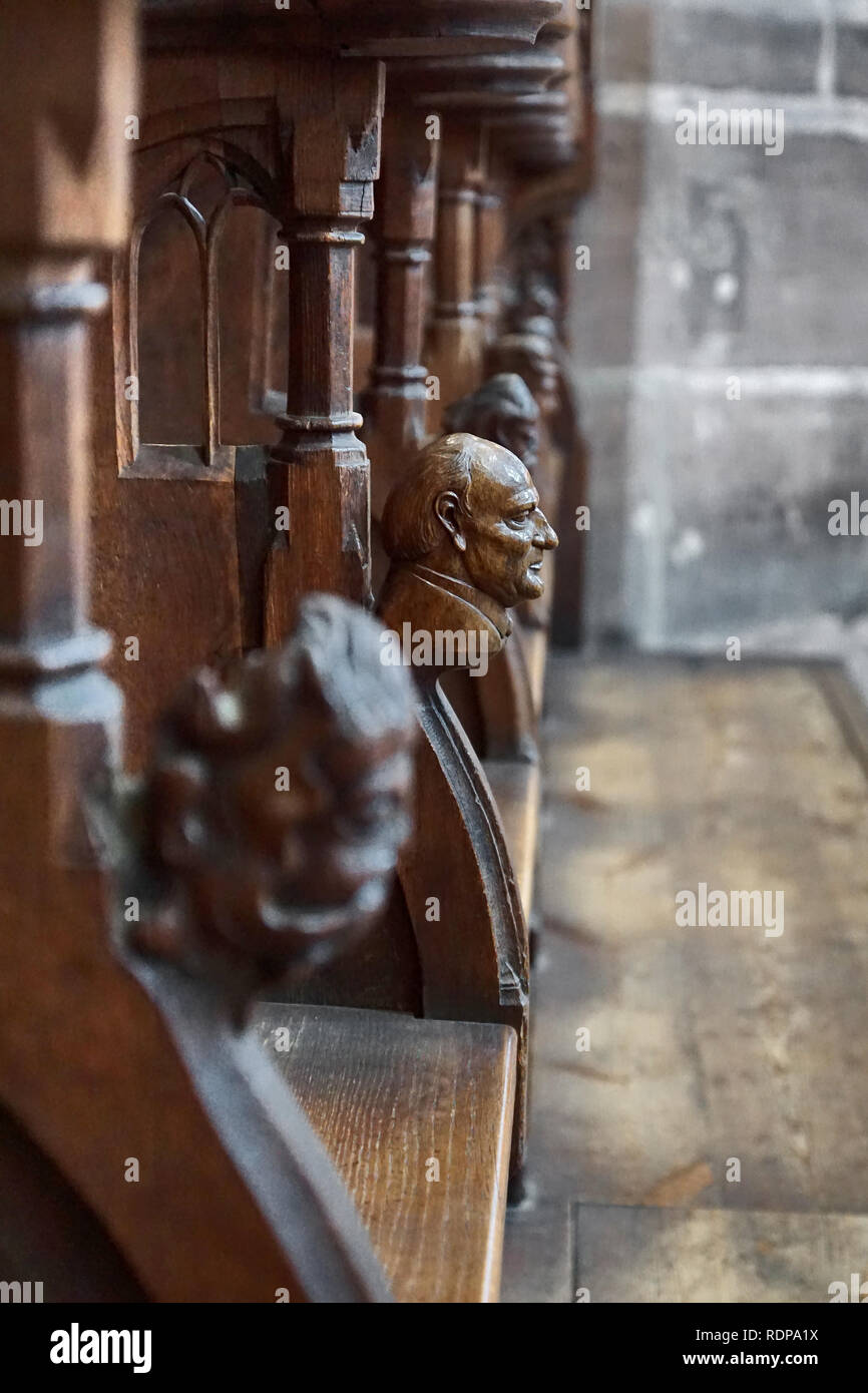 Wooden figure on chair in the sanctuary of church, Nuremberg, Germany Stock Photo
