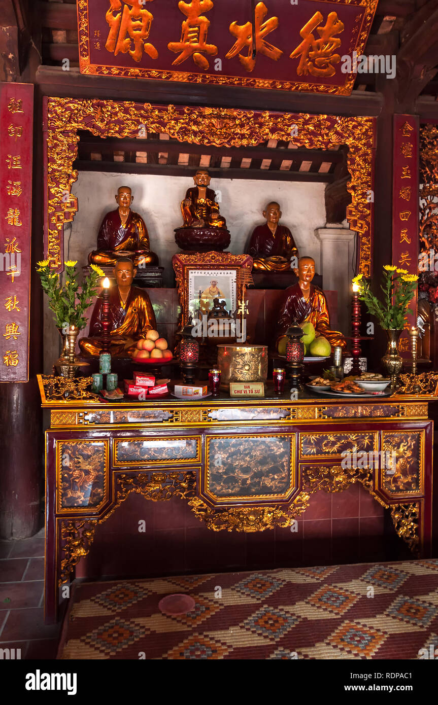 Chua Tran Quoc Temple shrine with statues and offerings, the oldest