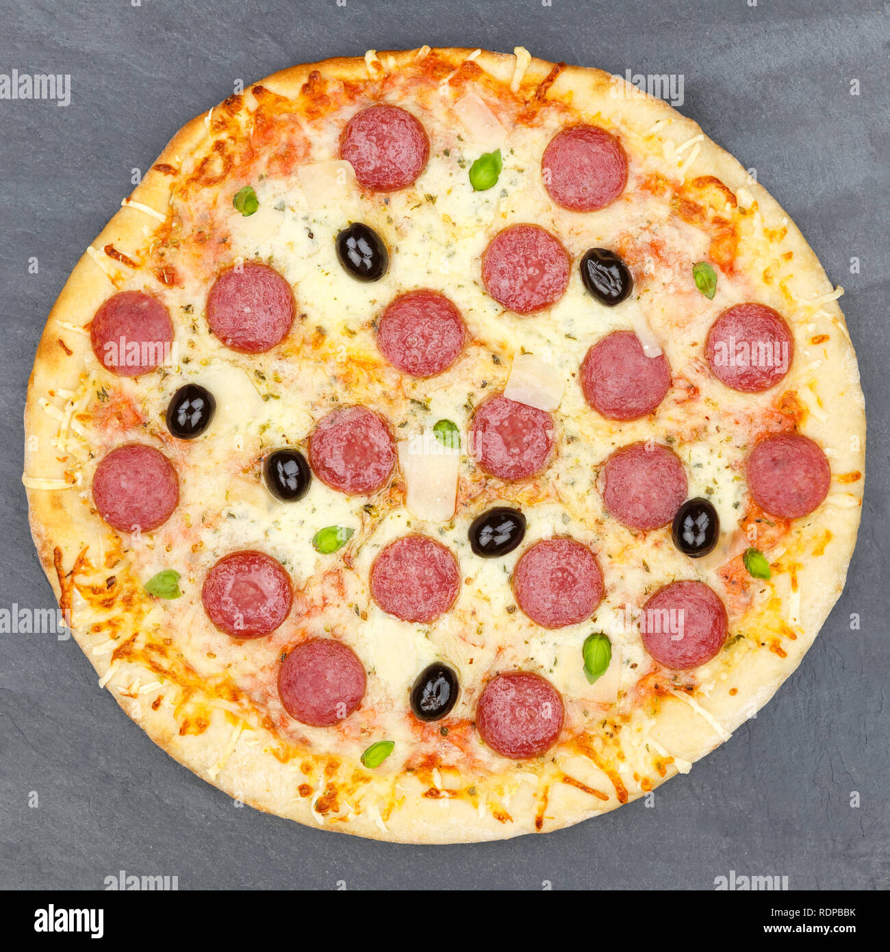 Pizza pepperoni salami from above square on a slate Stock Photo