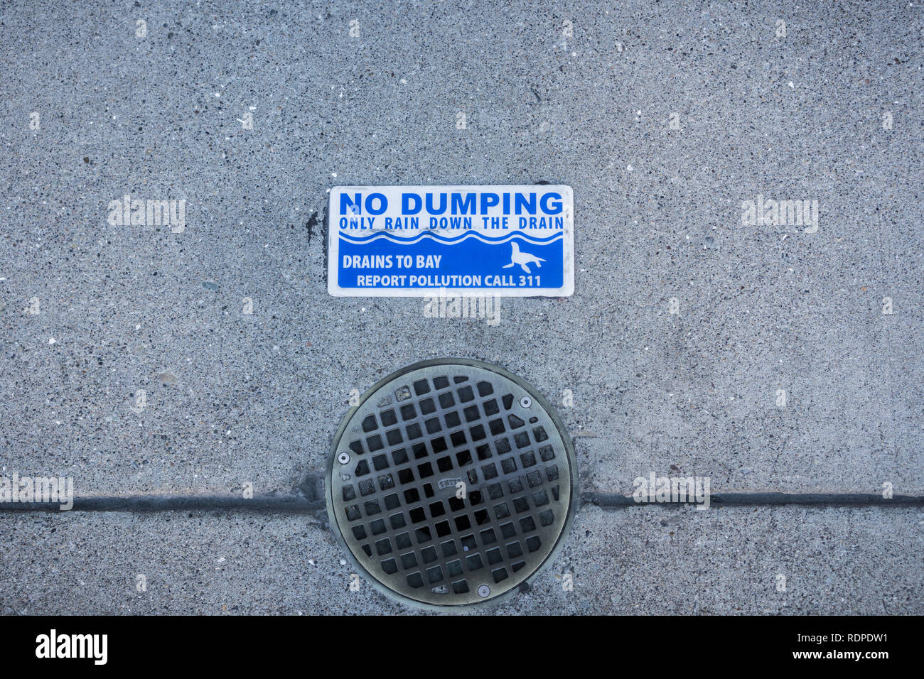 'No Dumping, only rain down the drain' sign on San Francisco Sidewalks and Streets Stock Photo
