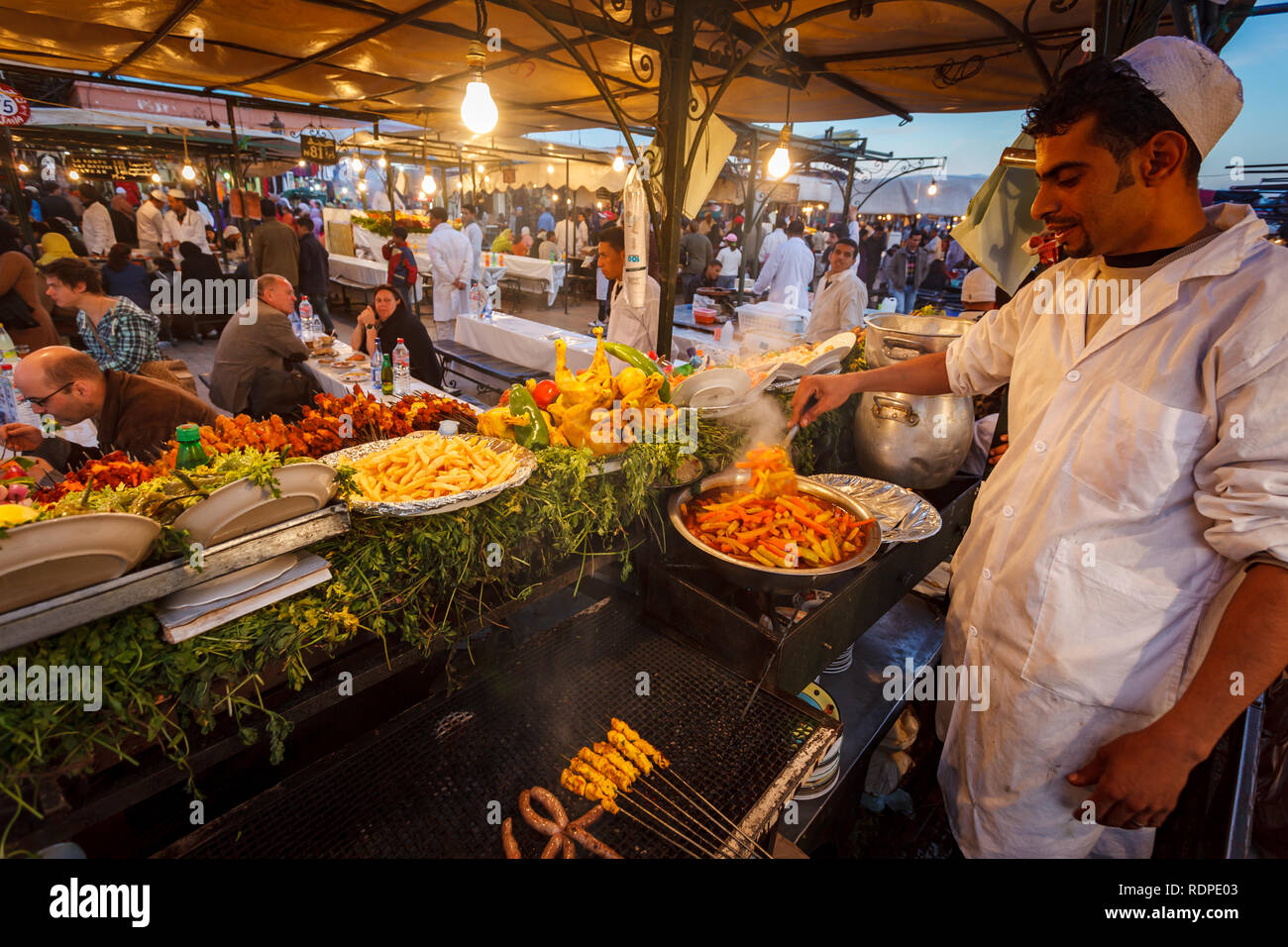 Closeup of chef preparing french fries  at Marrakesh public market stall Stock Photo