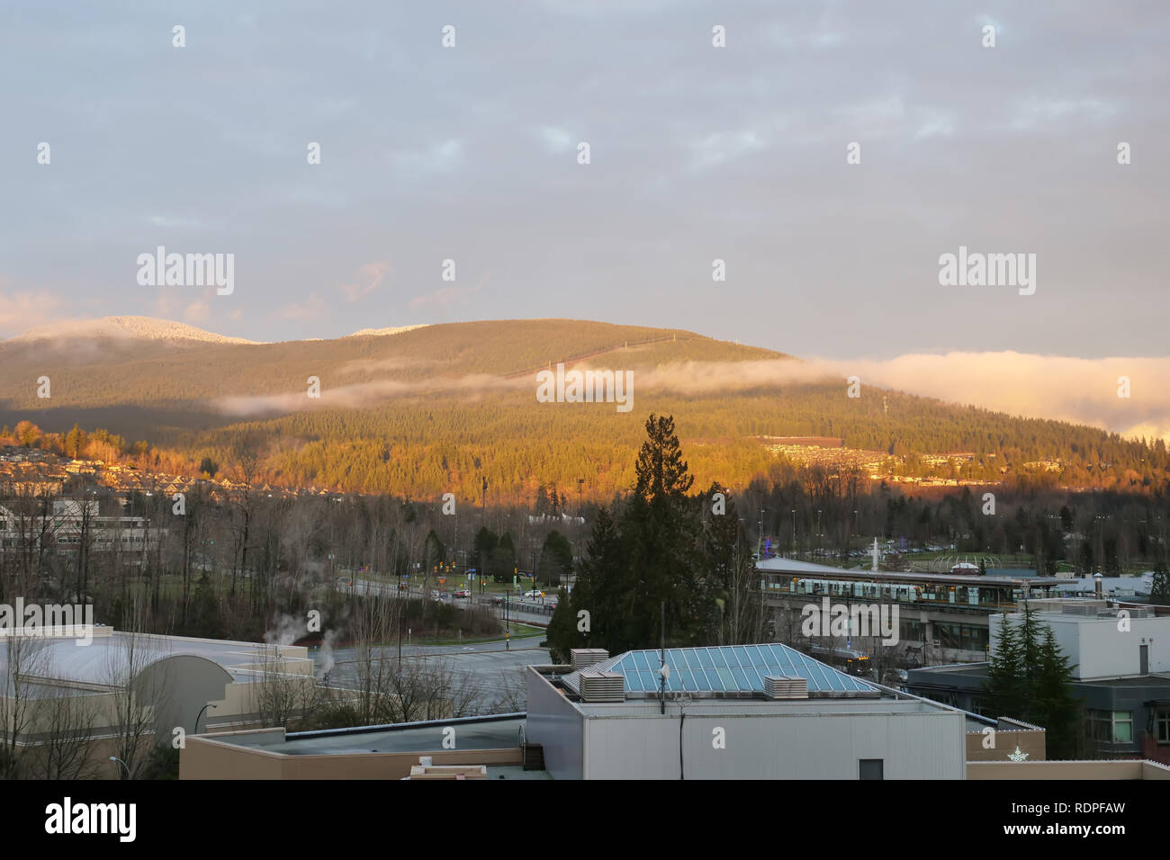 View of low rise apartment and house on mountain during cold winter on sunny afternoon Stock Photo