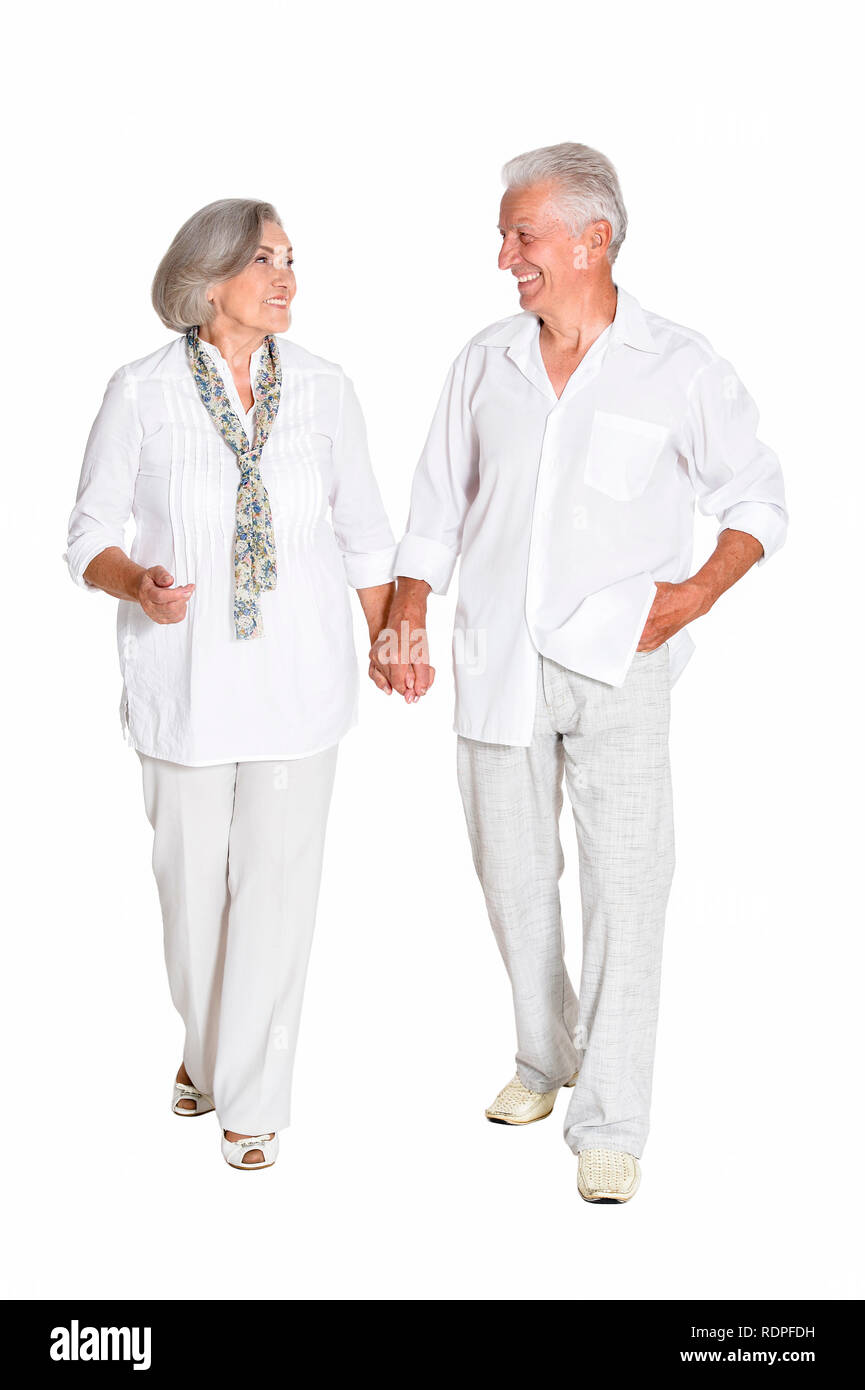 Senior couple holding hands isolated on white background, full length ...