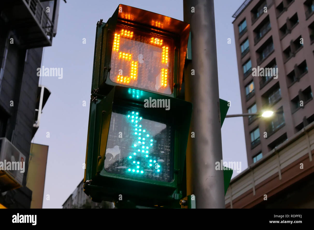 Close up of city traffic light turns on green for pedestrian walking Stock Photo