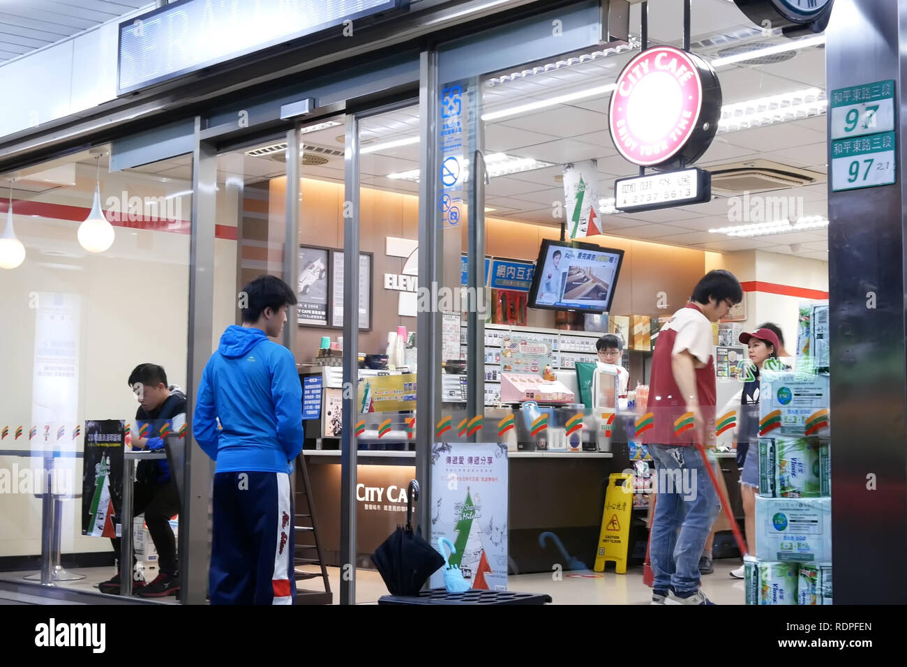 Taipei, Taiwan - December 01, 2018 : Storefront of people leaving of main entrance at 7 eleven store Stock Photo
