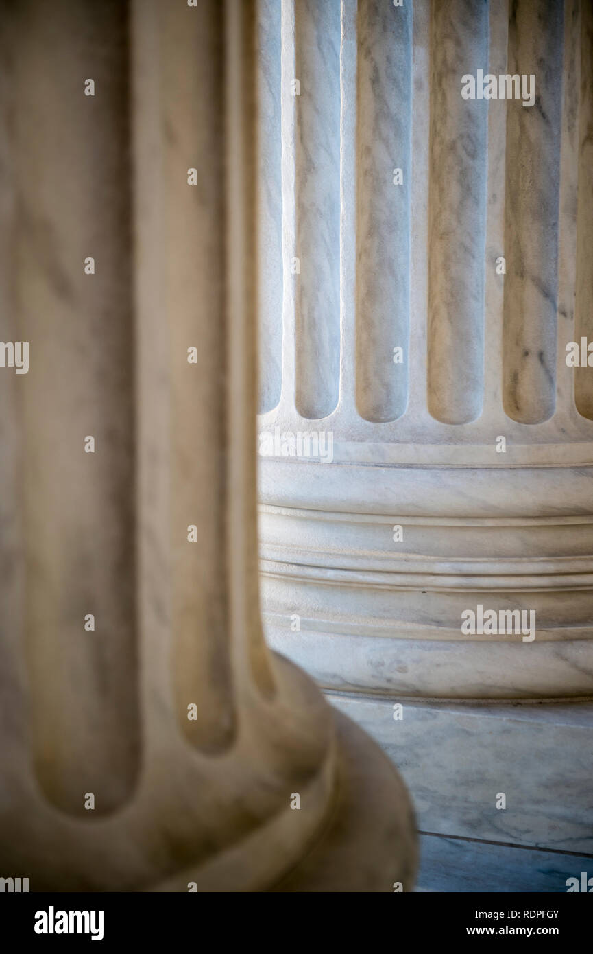 Abstract close-up of the neoclassical white marble fluted columns at the entrance to the US Supreme Court Building in Washington DC Stock Photo