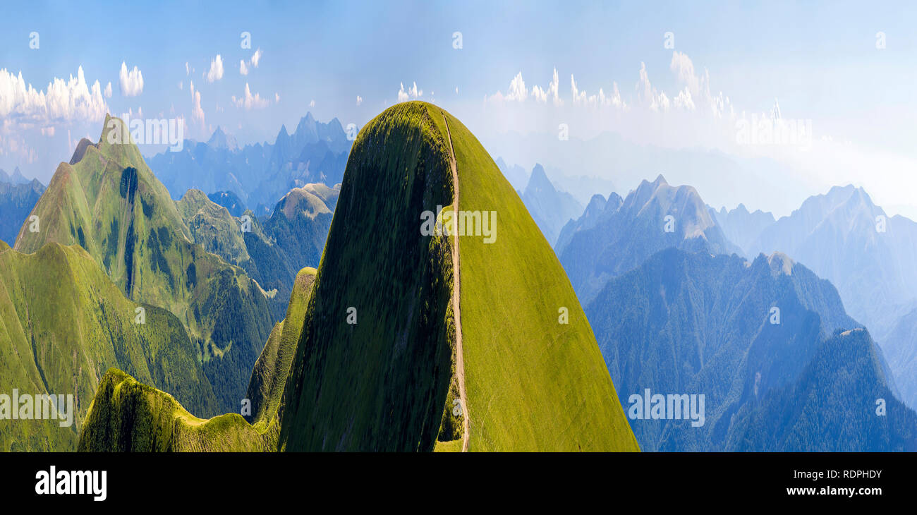 Panorama of green hills in summer mountains with gravel road for ...