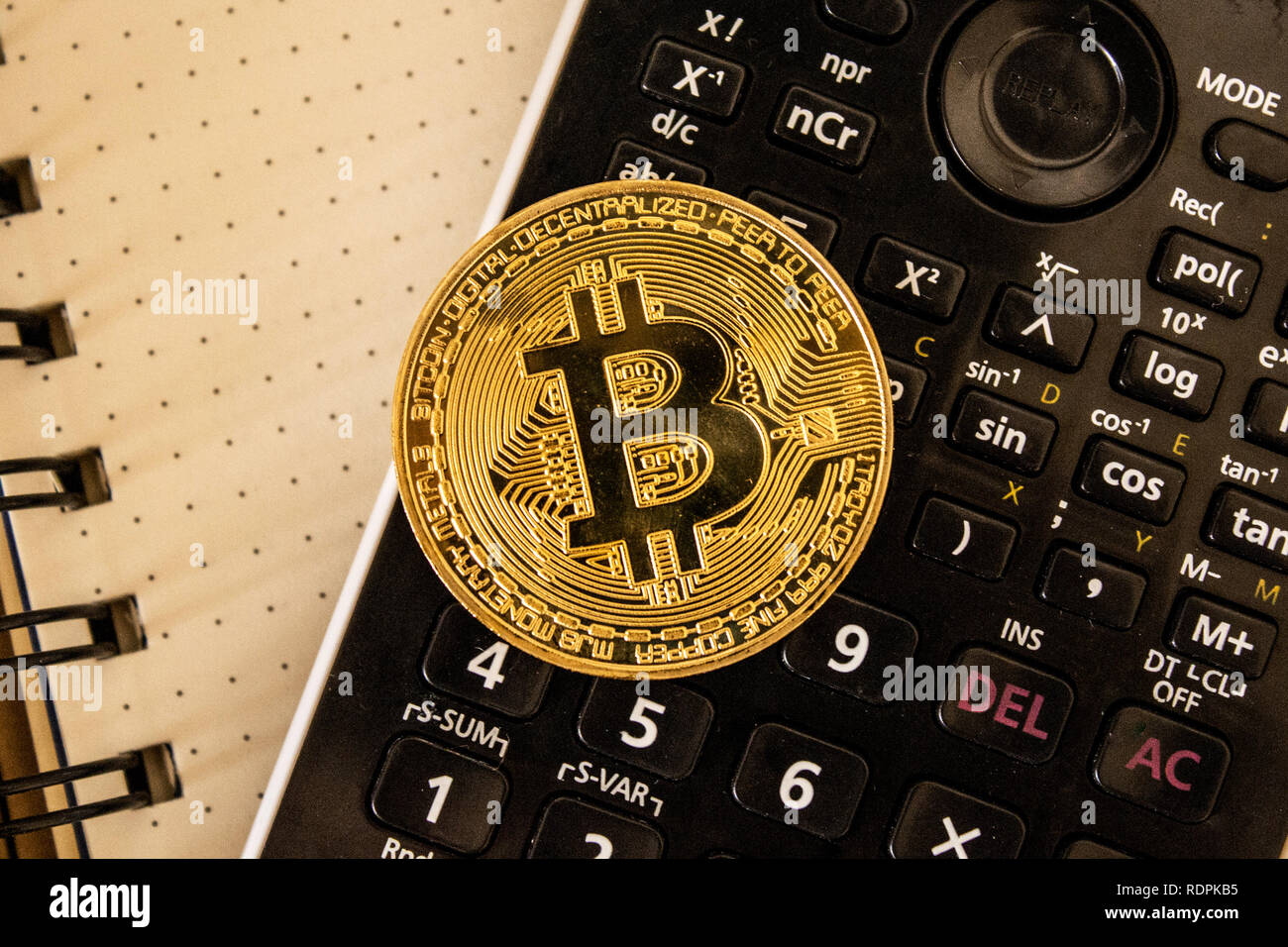 Bitcoin on top of calculator Stock Photo - Alamy