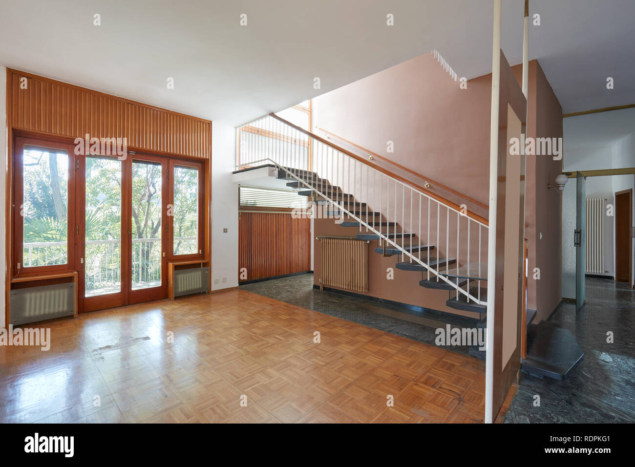 Empty living room with staircase, apartment interior in old house Stock Photo