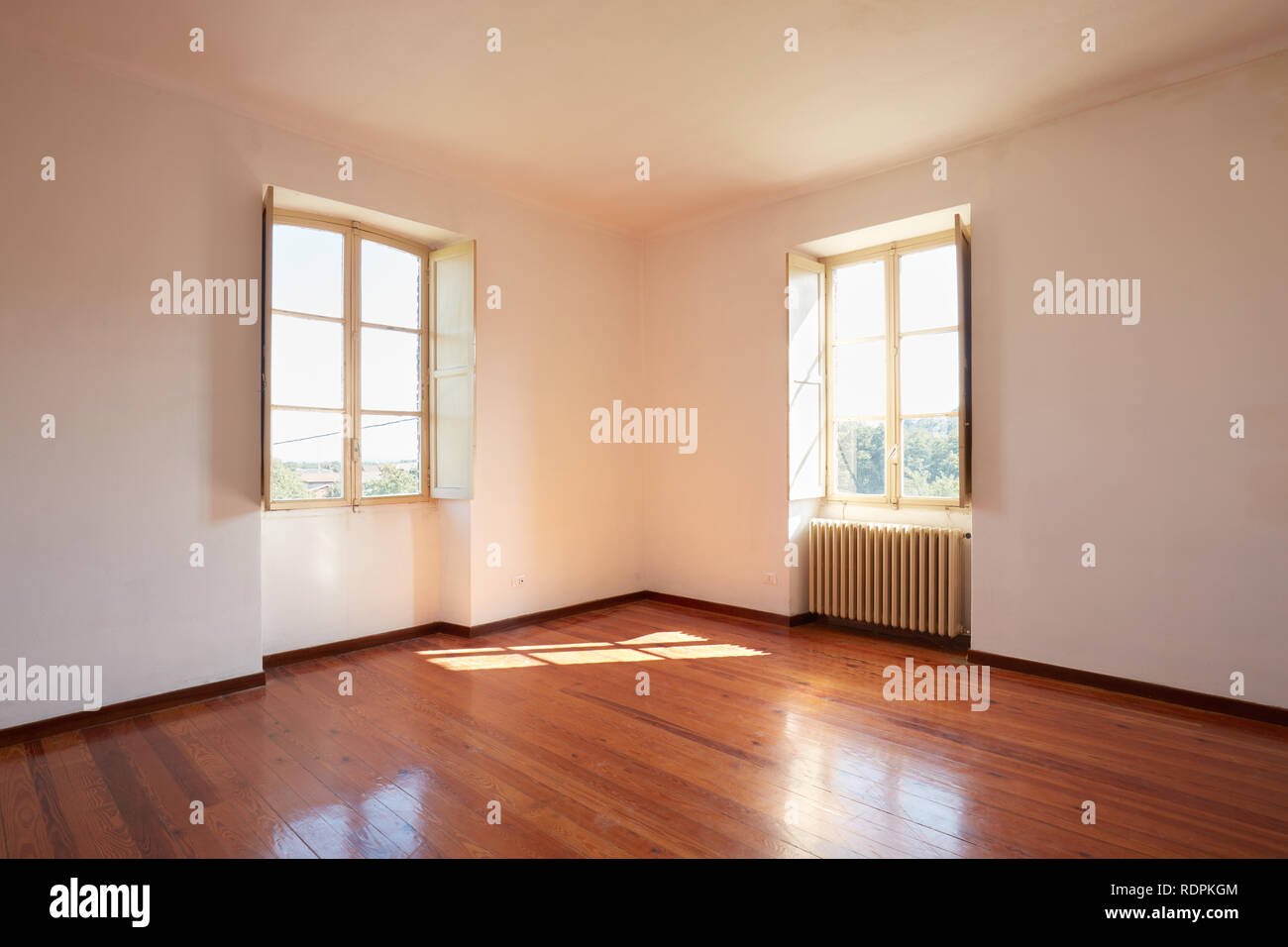 Old room with wooden floor in a country house, sunlight Stock Photo