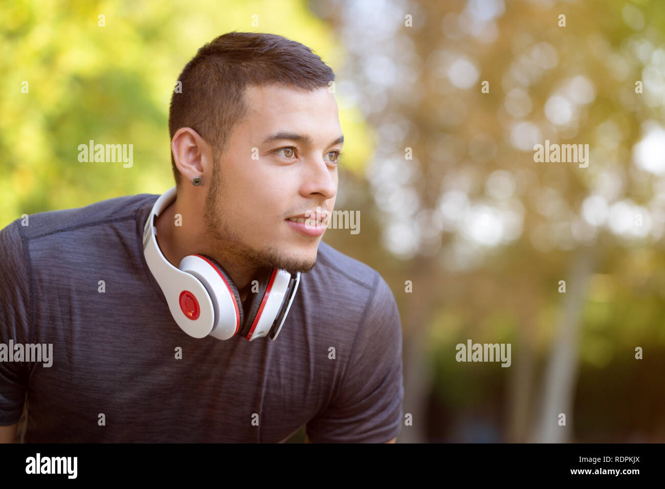 Young latin man runner looking future thinking running jogging sports training fitness workout copyspace copy space outdoor Stock Photo