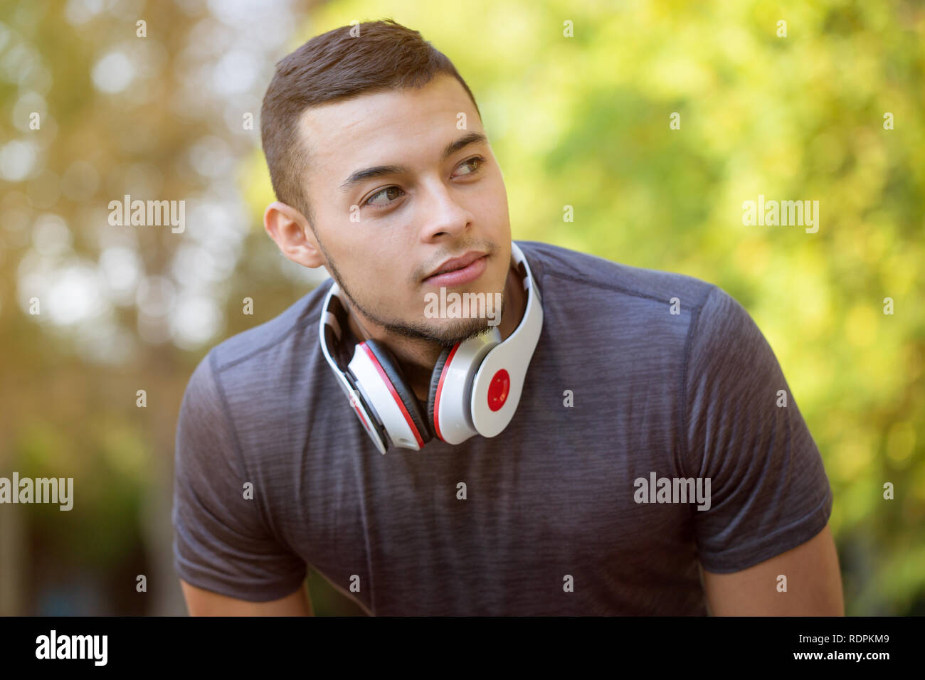 Young latin man runner looking thinking running jogging sports training fitness workout copyspace copy space outdoor Stock Photo
