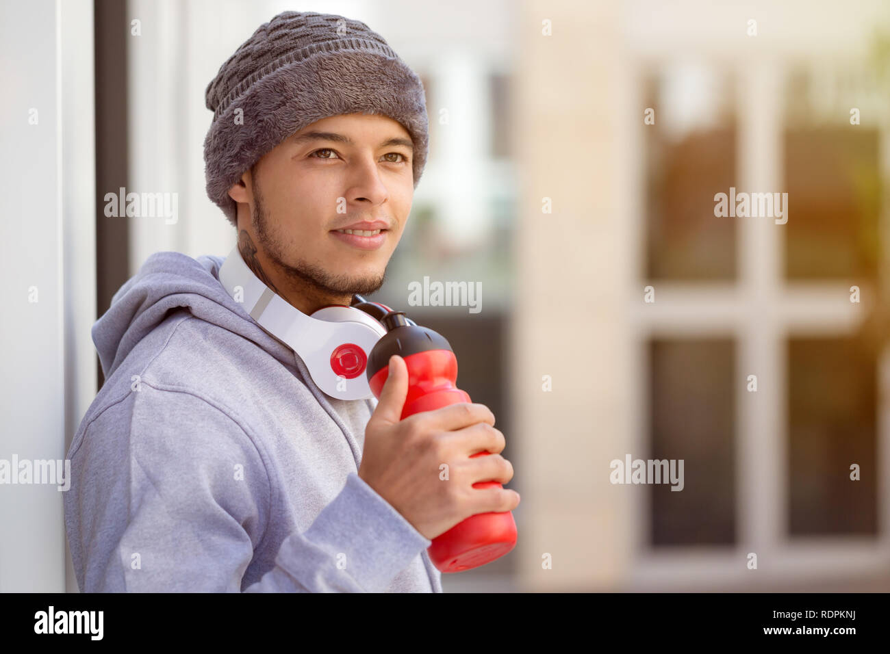 Sports training young latin man drinking water looking up thinking runner copyspace copy space outdoor Stock Photo