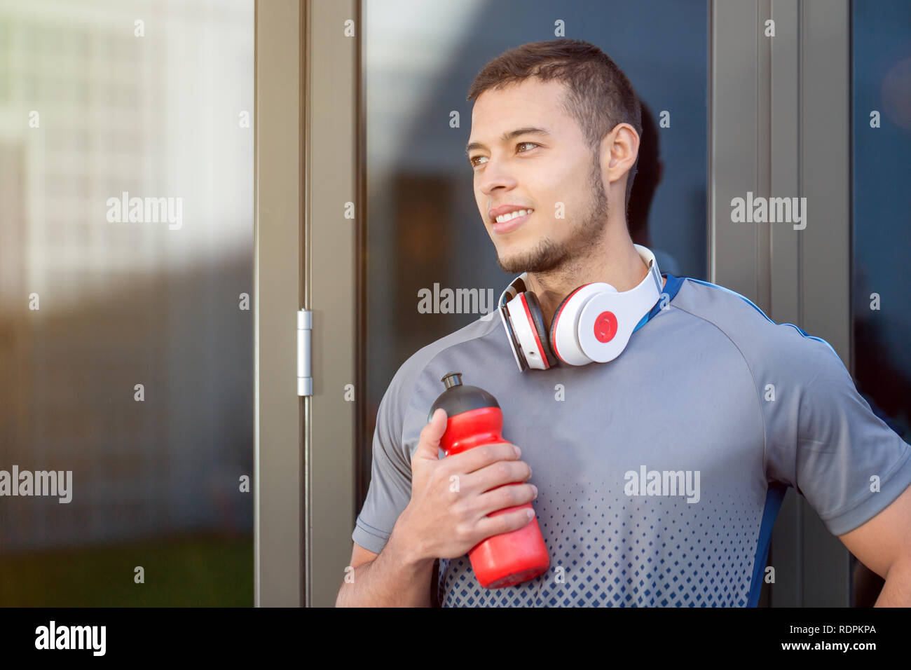 Young latin man water bottle looking thinking day dreaming runner copyspace copy space running sports training fitness outdoor Stock Photo