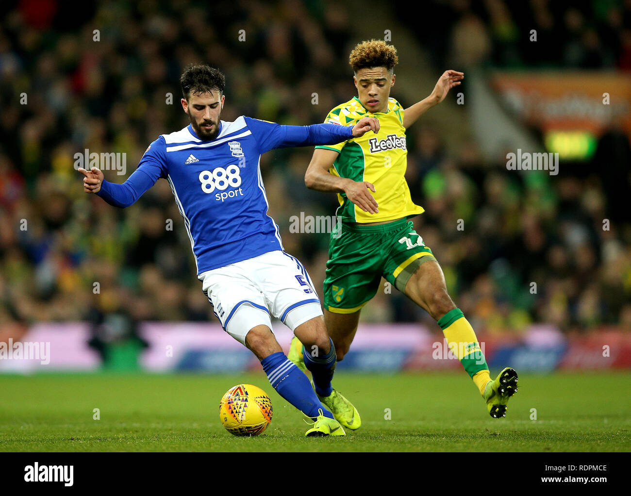 Birmingham City's Maxime Colin (left) and Norwich City's Jamal Lewis (right) battle for the ball during the Sky Bet Championship match at Carrow Road, Norwich. Stock Photo