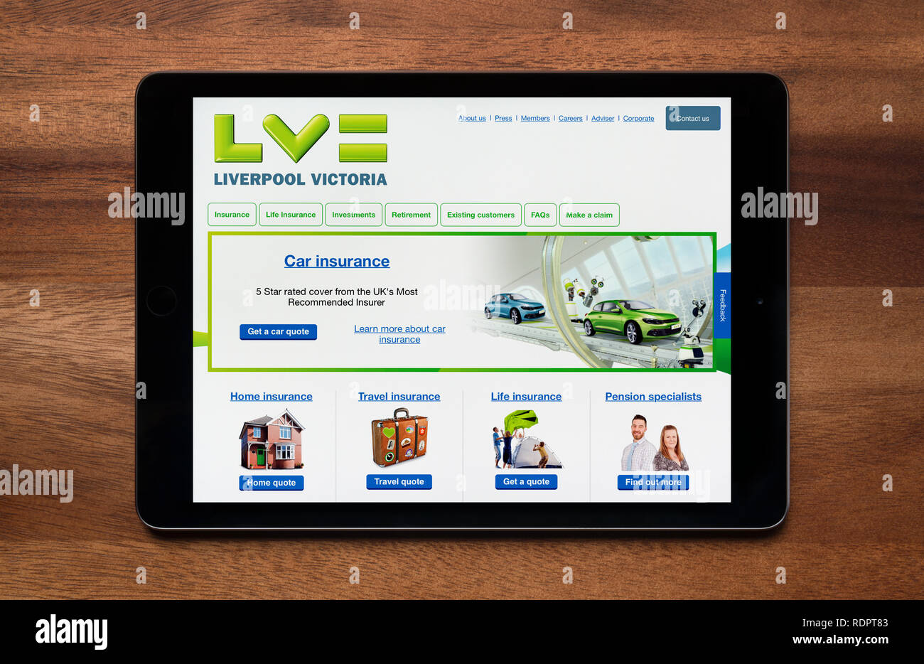 The website of Liverpool Victoria is seen on an iPad tablet, which is resting on a wooden table (Editorial use only). Stock Photo