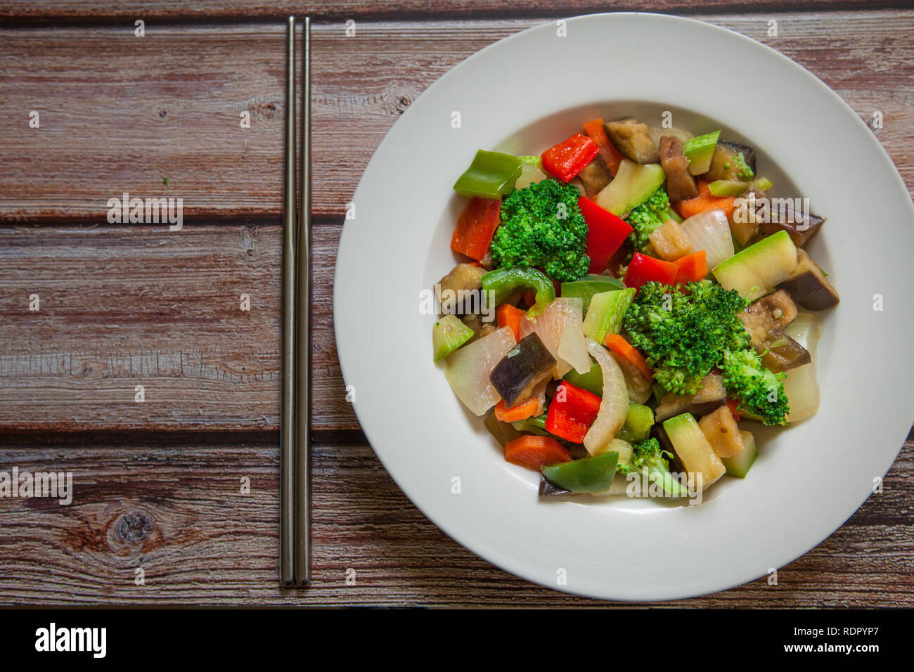 styrfry chinese style vegetables on wok with chopstick Stock Photo Alamy