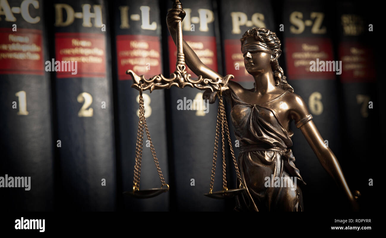 Lady justice, themis, statue of justice on books background. Law concept with justice figurine in library Stock Photo