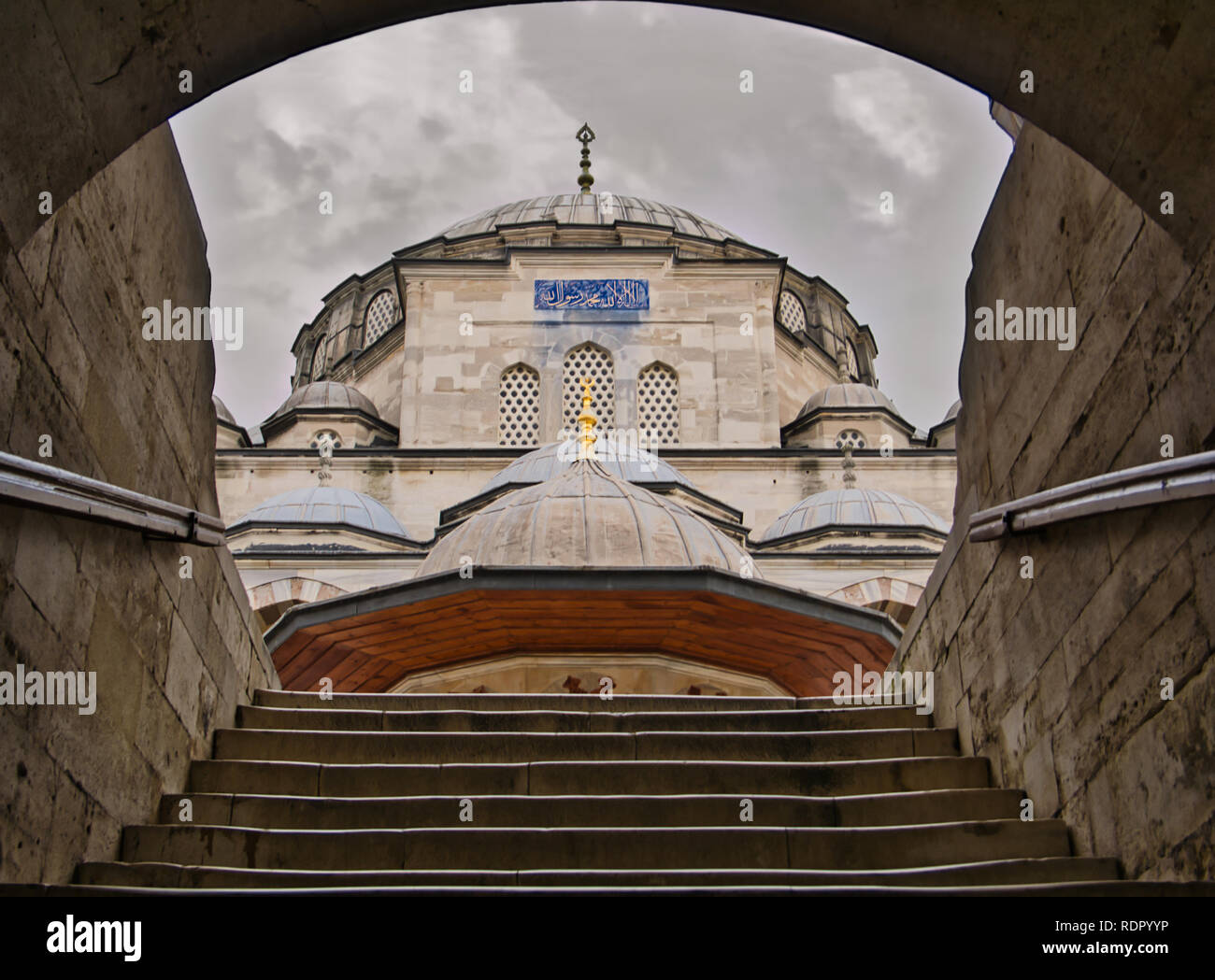 Vaulted entrance with an old stone staircase to a mosque in Istanbul Stock Photo