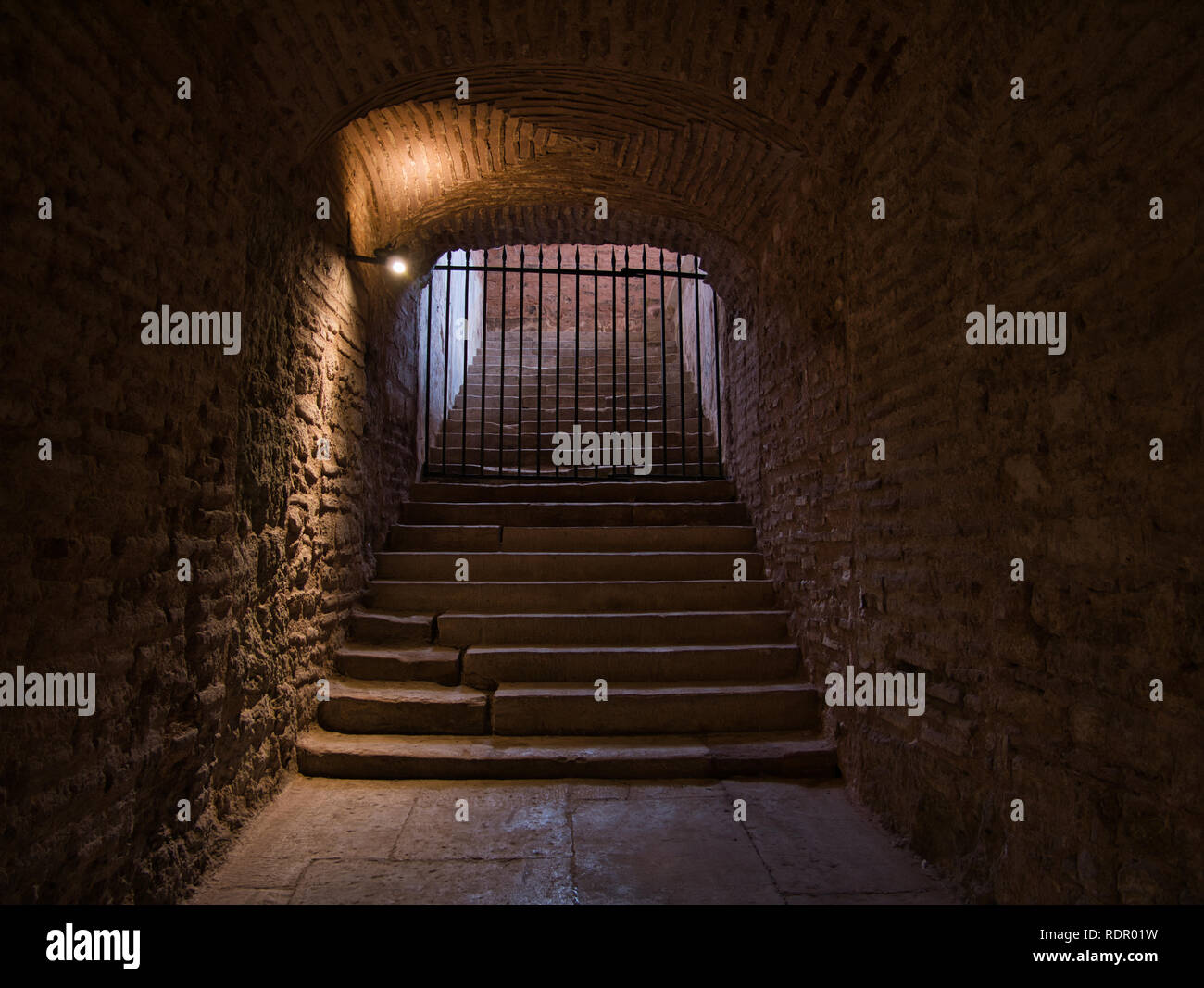 Staircase in a cellar vault blocked by a grid Stock Photo
